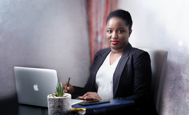 Image of Olufunke sitting at a computer
