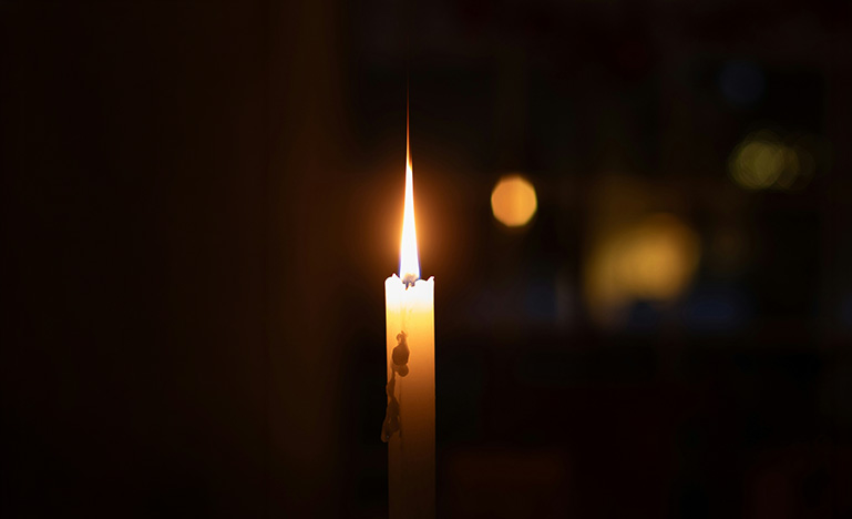 A single candle in a dark room