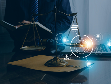 A set of balance scales on a desk with legal documents, overlaid with glowing digital icons representing technology and data, symbolizing the intersection of law and modern communication.