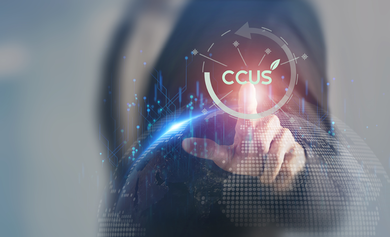 Person interacts with a digital display featuring the acronym CCUS and technology-themed graphics.