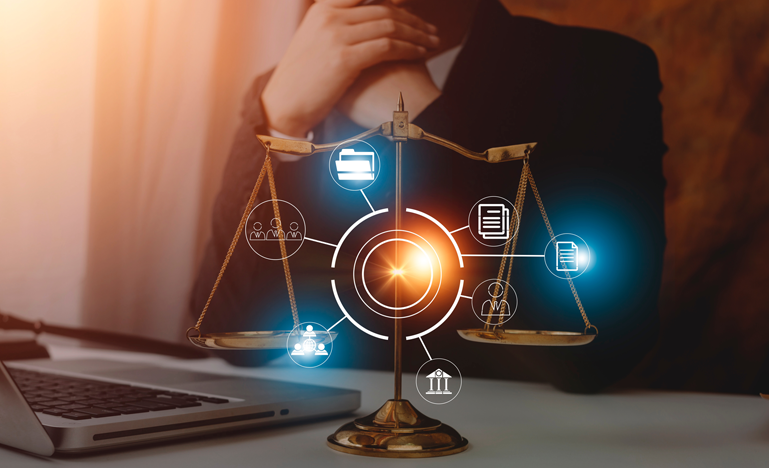 A person sits at a desk with a laptop, behind a brass balance scale and digital legal icons representing law, documents, and communication.
